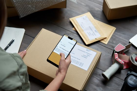 A man scanning the barcode on a package